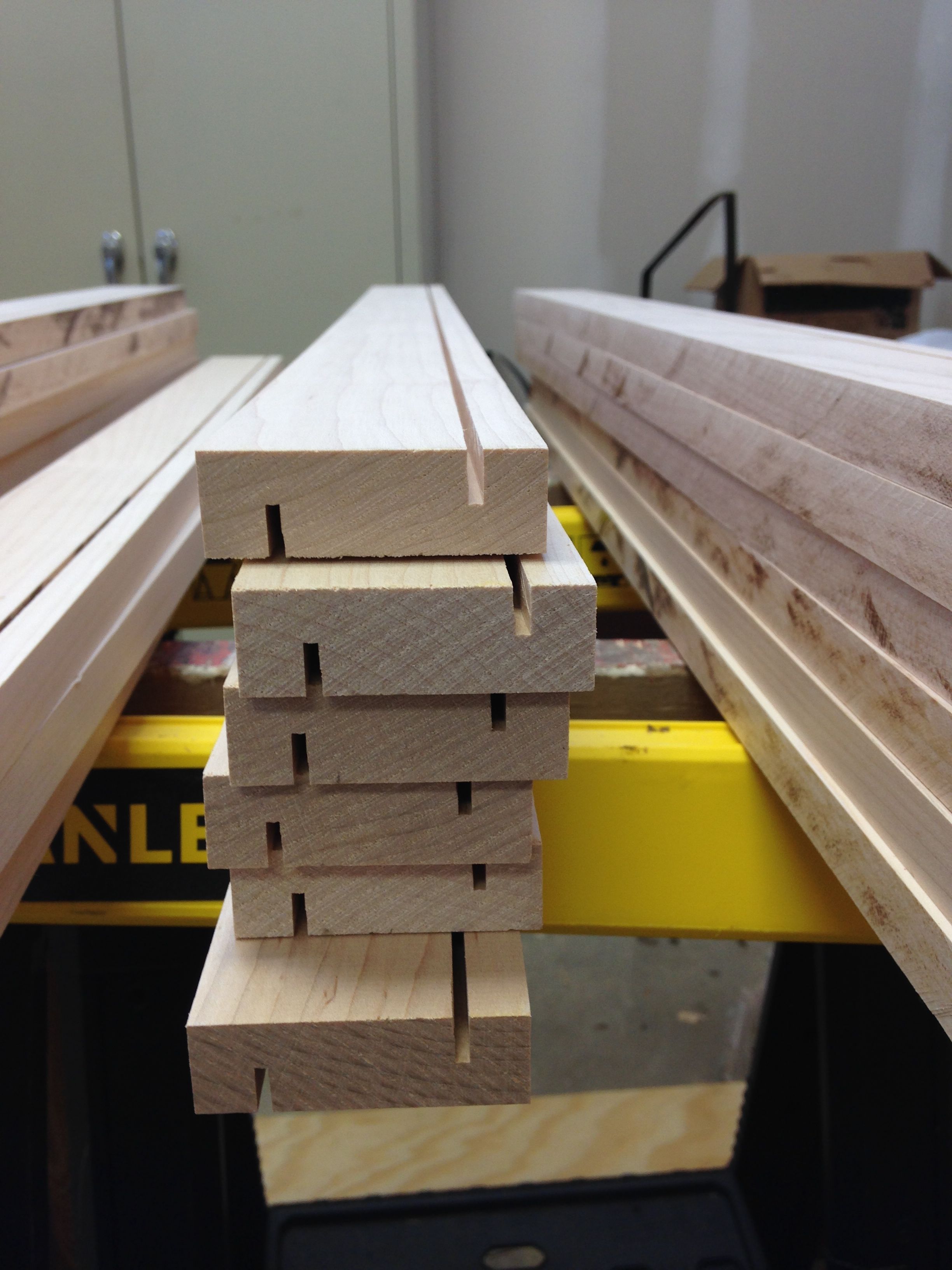 Wood strips cut to width and with first cuts for the overlapping scheme to substitute for tongue and groove.